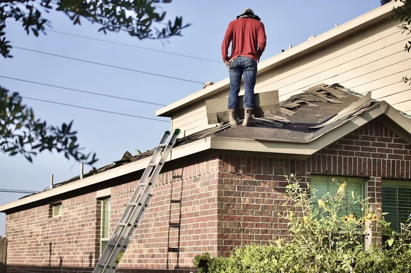 Professional roofer working on a residential roof in Country Club Estates